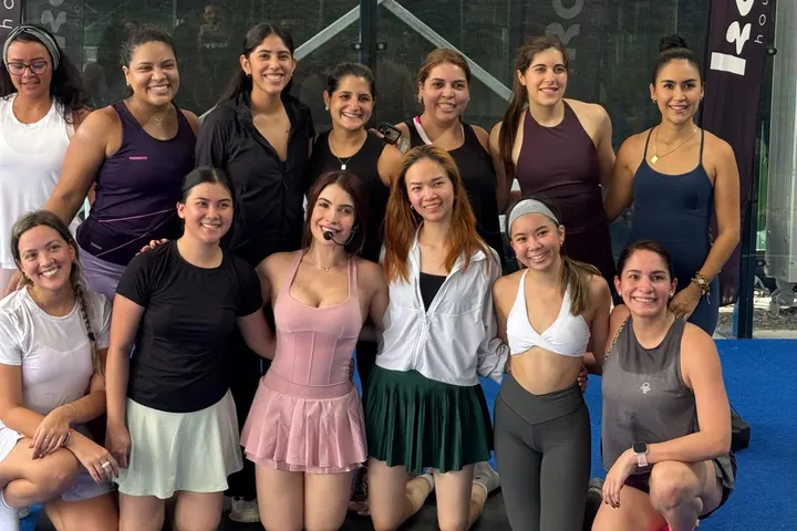 Paola Porcell posa con un grupo de mujeres sonrientes en una cancha deportiva
